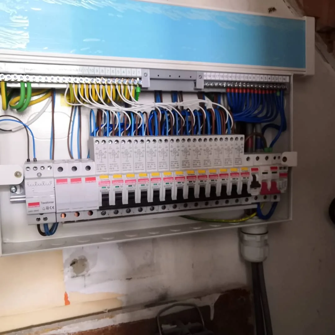 New dual-row consumer unit with RCBOs, neatly wired and labelled, replacing the old board