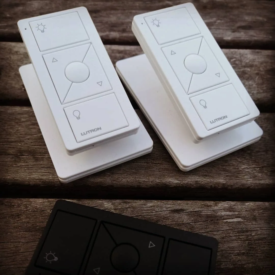 Two Lutron Pico wireless lighting remote controls, part of a Lutron RA2 system